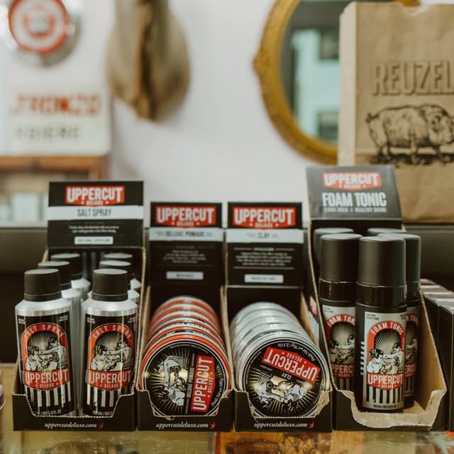 Uppercut Deluxe pomades and styling products on the shop shelf