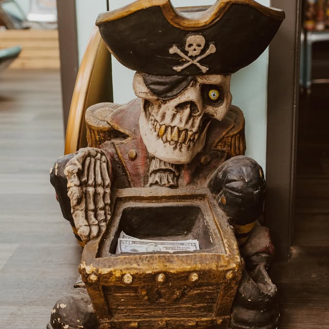 The pirate skeleton tip box that guards the counter